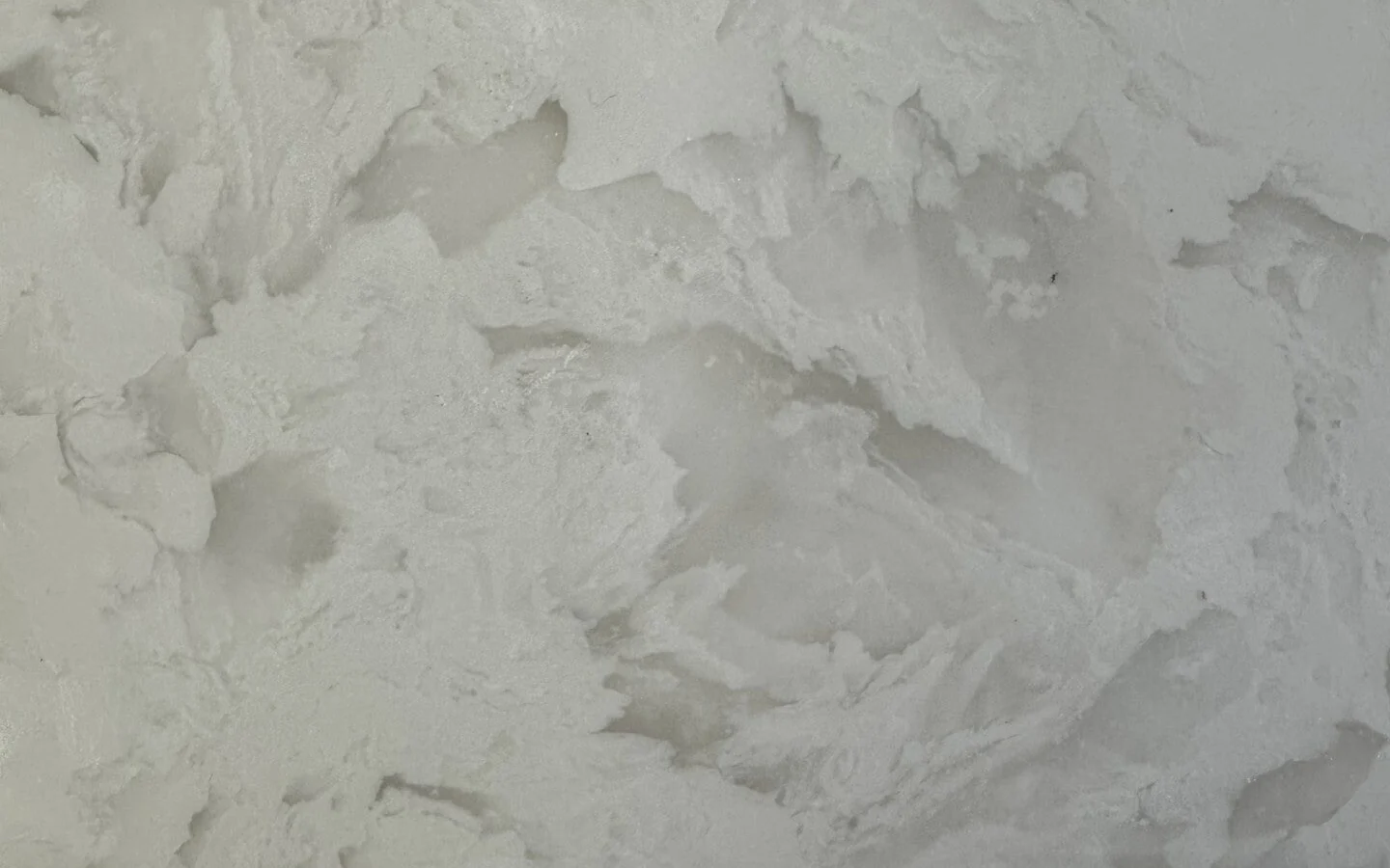 Cultured marble surface sample with pale white and soft gray cloudlike patterning.
