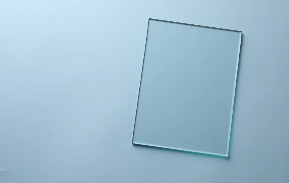 A clear rectangular glass pane on a pale blue background.