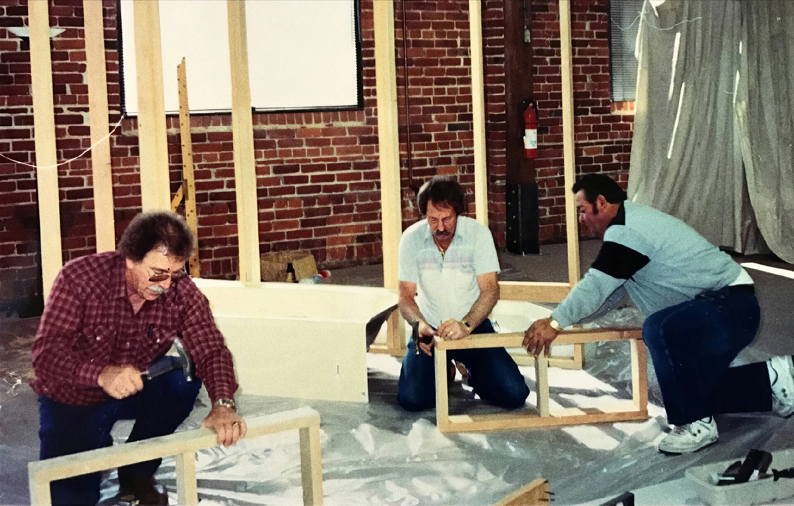 Ron Ebel on the left, Bob Sutton in the middle and Alfredo, their close friend and handyman, on the right, working on framed panels.