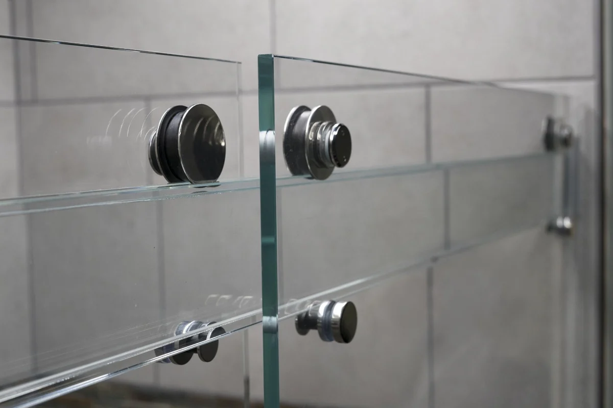 Original detail photograph of the Titan Phantom glass header, dark roller fittings and clear panels.